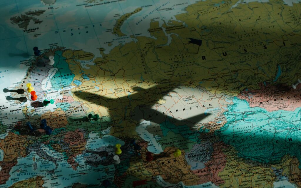 Shadow of an airplane on a map of Europe, highlighting travel and exploration concepts.